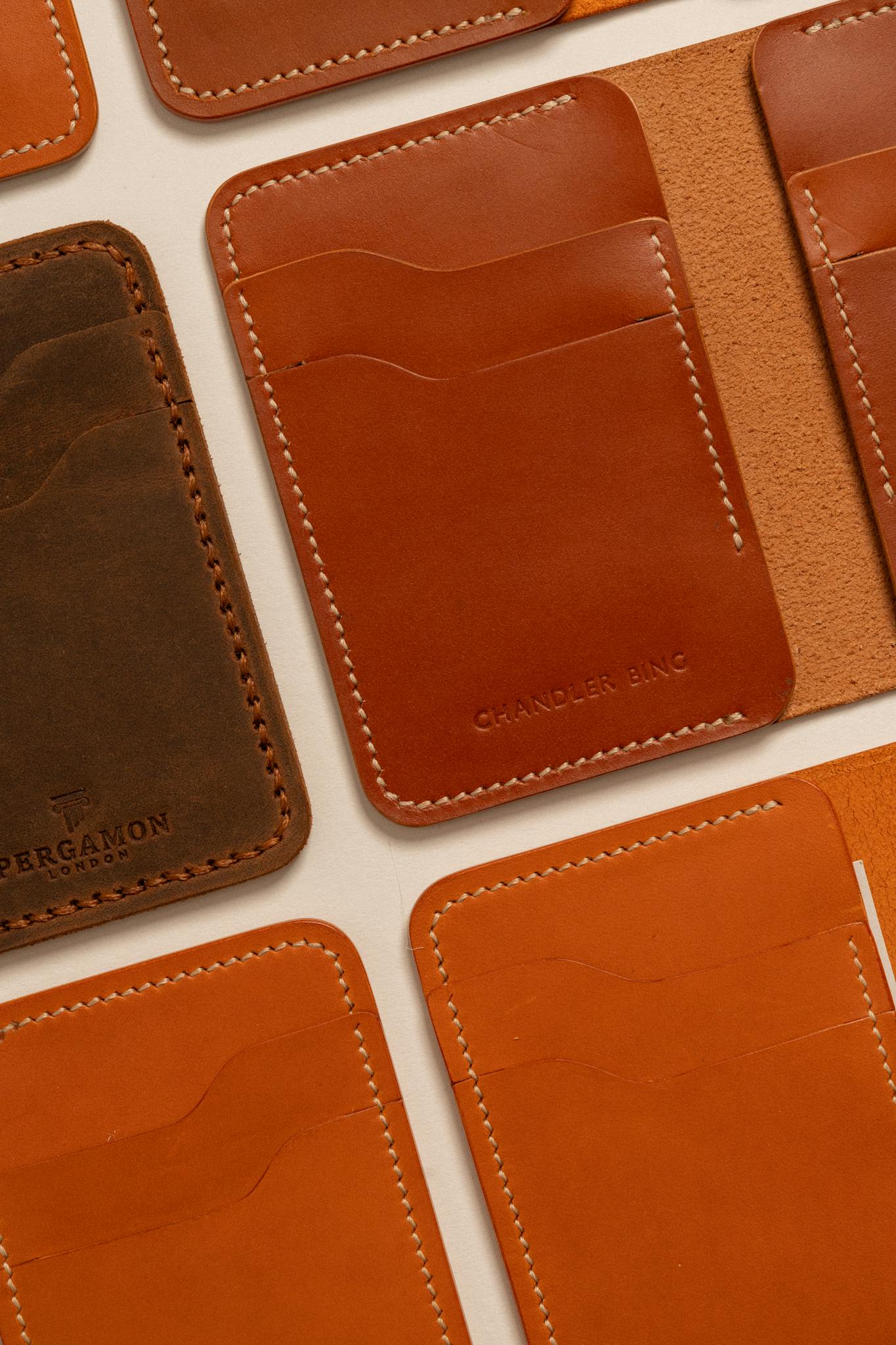Top view of stylish leather cardholders arranged aesthetically, showcasing various shades of brown.